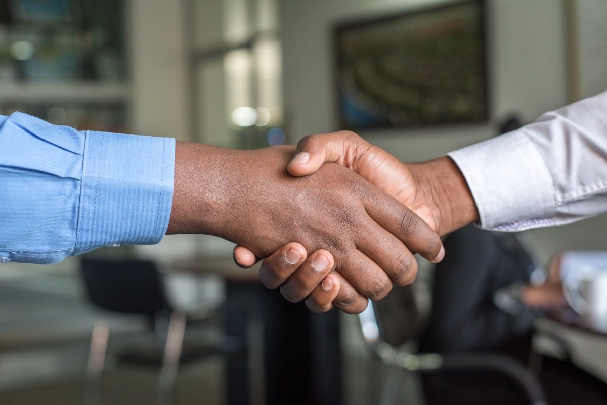 Small business owner shaking hands with a satisfied customer